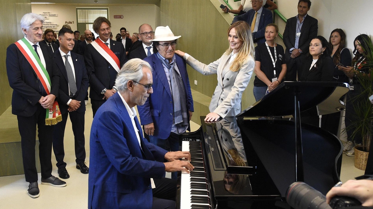 Taglio del nastro per l’hub educativo di Sforzacosta, costruito dalla Fondazione del tenore. Al Bano intona "Nel sole", ma un acquazzone manda a monte il programma della cerimonia.