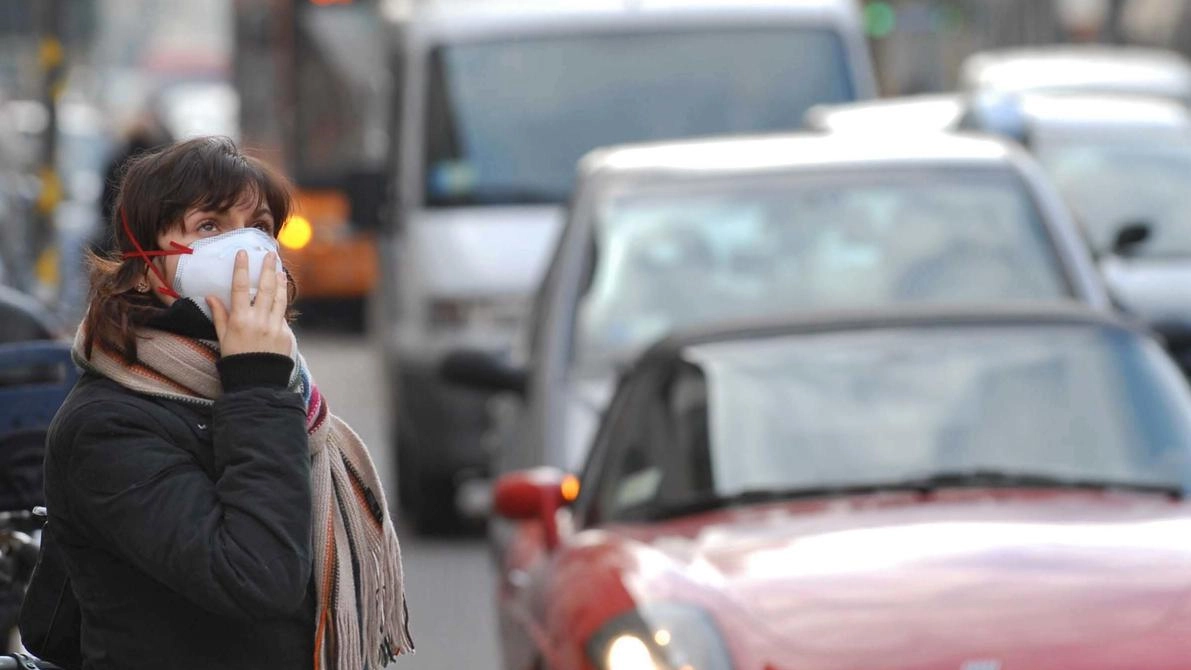 Una donna bloccata all’interno del traffico, dominato dallo smog